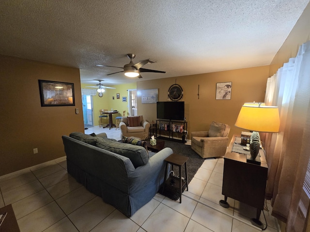 tiled living room with ceiling fan and a textured ceiling