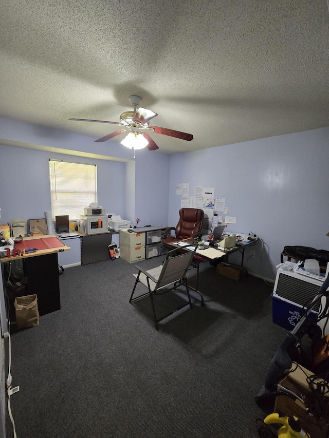 office featuring dark colored carpet, ceiling fan, and a textured ceiling