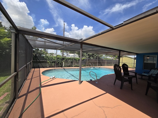 view of pool featuring a patio and glass enclosure