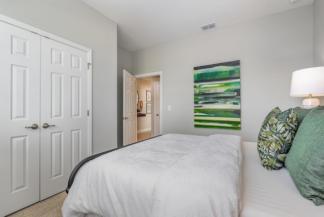 carpeted bedroom with a closet