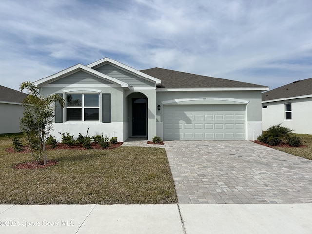 ranch-style house featuring a garage and a front yard