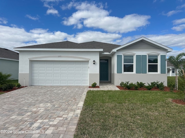 single story home with a front lawn and a garage