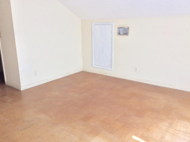 unfurnished room with lofted ceiling