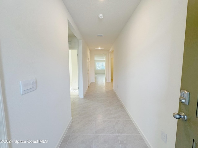 corridor featuring light tile patterned floors