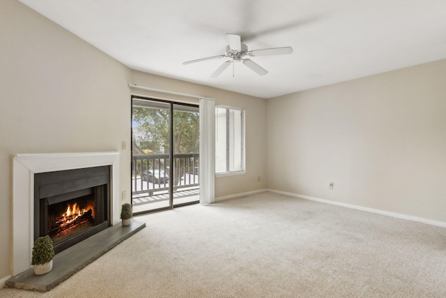 unfurnished living room featuring carpet floors and ceiling fan