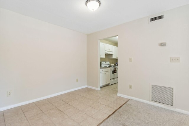 unfurnished room with light tile patterned floors