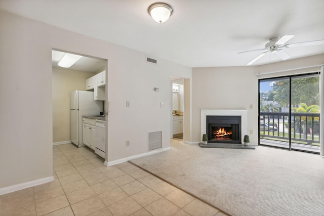 unfurnished living room with light carpet and ceiling fan