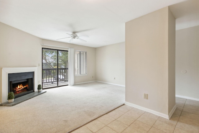 unfurnished living room featuring light colored carpet and ceiling fan