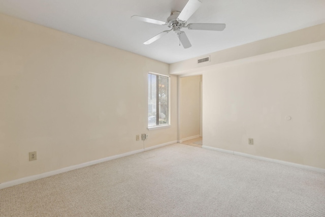 unfurnished room featuring light carpet and ceiling fan