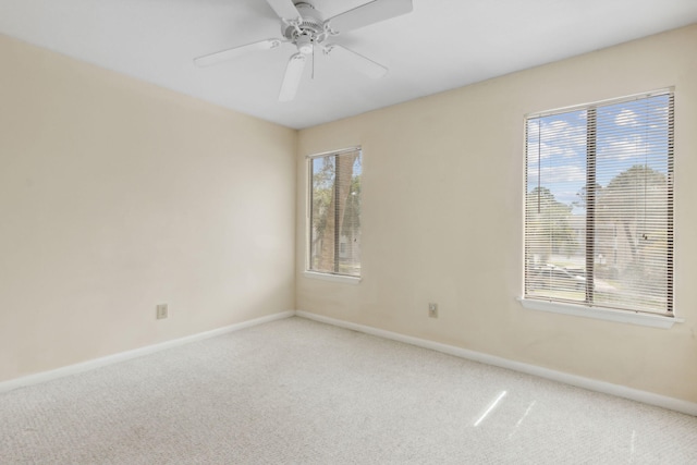 carpeted spare room with ceiling fan