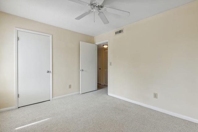 unfurnished bedroom with ceiling fan and light carpet