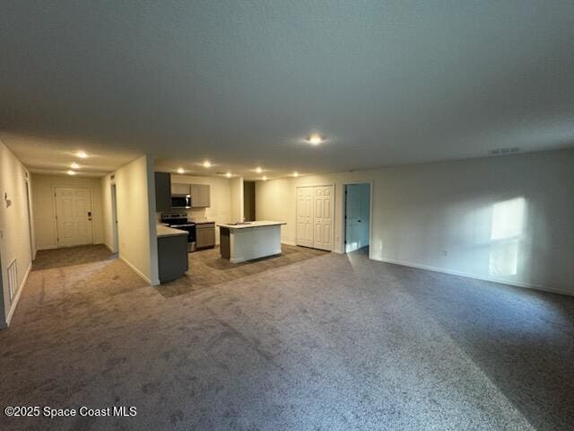 unfurnished living room with carpet flooring