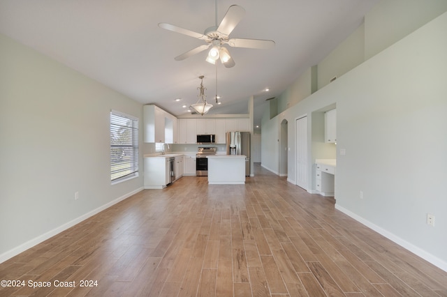 unfurnished living room with sink, ceiling fan, and light hardwood / wood-style floors