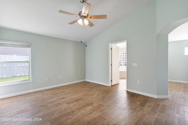 spare room with high vaulted ceiling, ceiling fan, and light hardwood / wood-style flooring