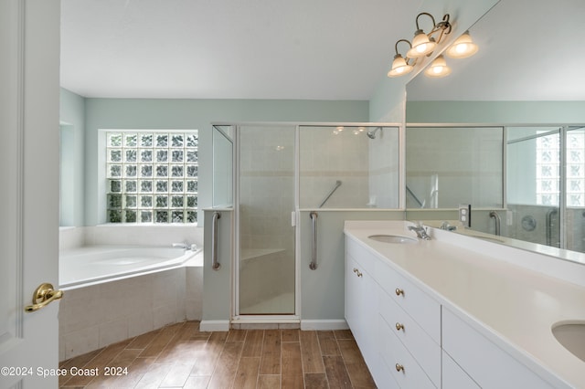 bathroom featuring vanity, hardwood / wood-style flooring, and shower with separate bathtub