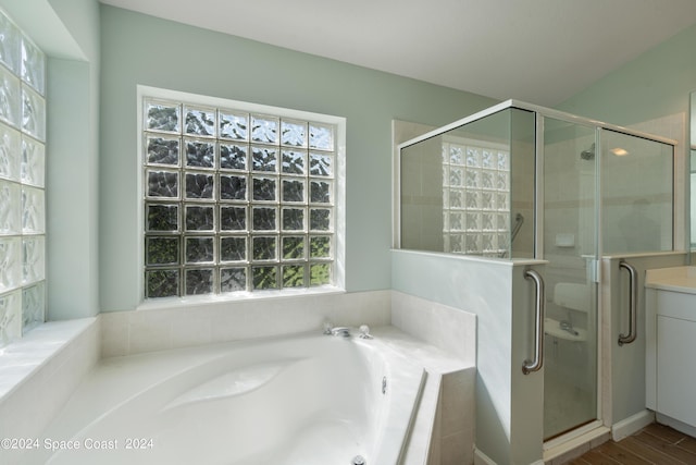 bathroom featuring a garden tub and a shower stall