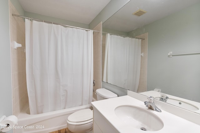 bathroom featuring shower / bath combo, visible vents, vanity, and toilet