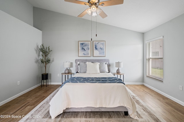 bedroom with vaulted ceiling, wood-type flooring, and ceiling fan