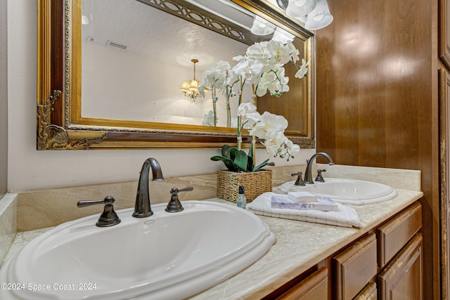 bathroom with a textured ceiling and vanity