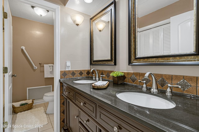 bathroom featuring vanity, toilet, and tile patterned floors