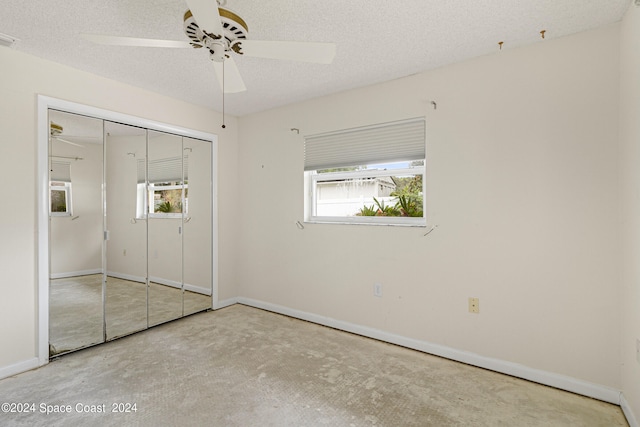 unfurnished bedroom featuring a textured ceiling, ceiling fan, and a closet