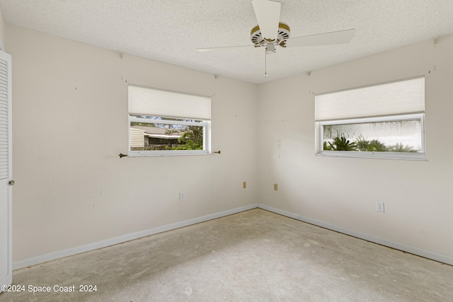 spare room with ceiling fan and a textured ceiling