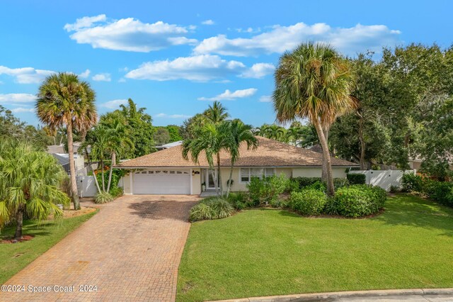 single story home with a garage and a front yard