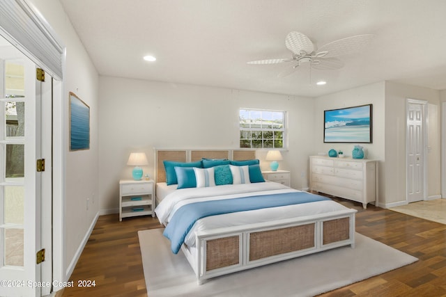 bedroom with ceiling fan and dark hardwood / wood-style flooring