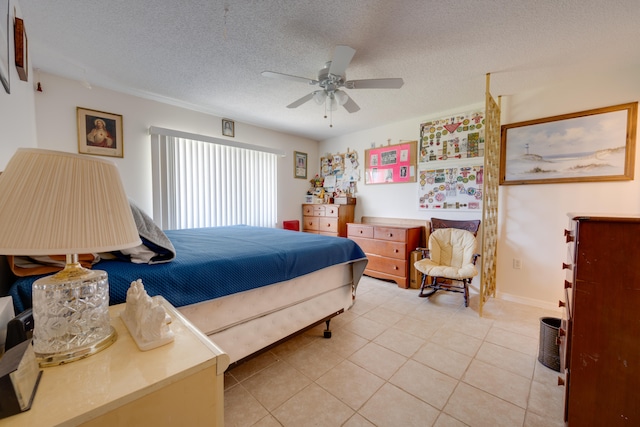 bedroom with a textured ceiling, ceiling fan, and light tile patterned floors