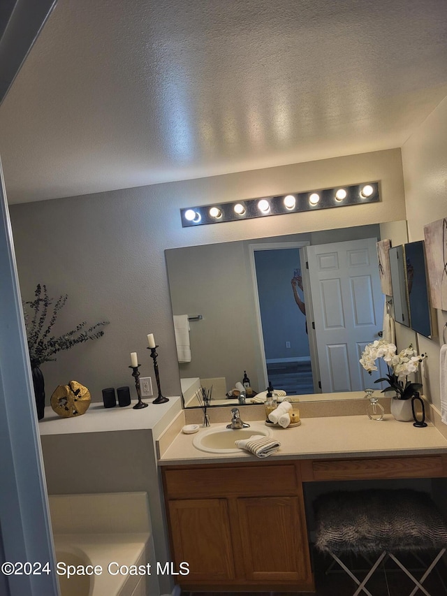 bathroom with vanity and a textured ceiling