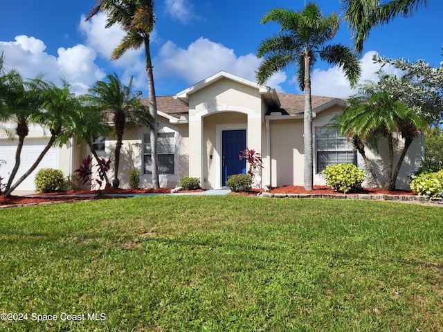 view of front facade featuring a front yard and a garage