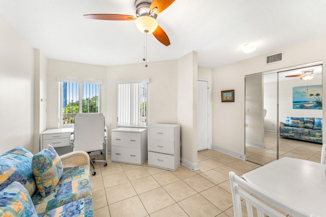 interior space featuring ceiling fan and light tile patterned floors