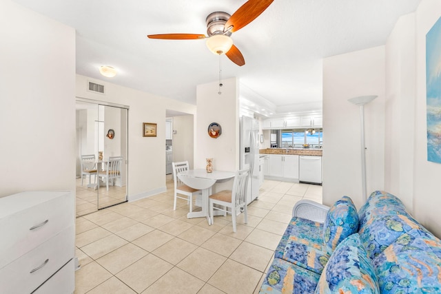 dining space with light tile patterned floors and ceiling fan