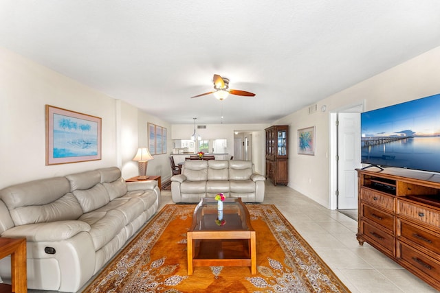 living room featuring light tile patterned flooring and ceiling fan