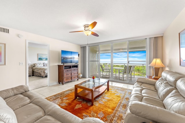 tiled living room featuring ceiling fan