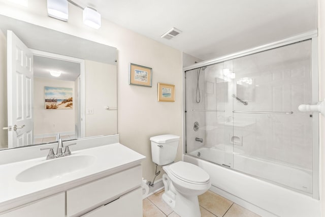 full bathroom featuring tile patterned floors, vanity, enclosed tub / shower combo, and toilet