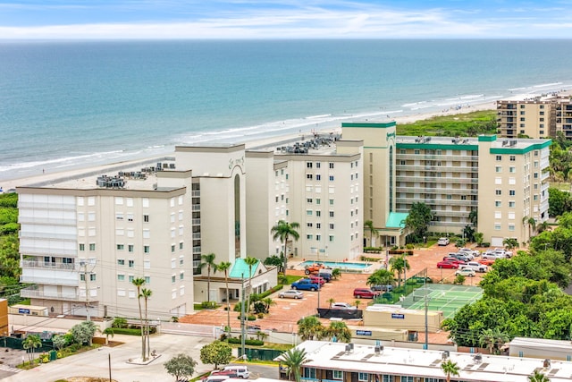 birds eye view of property with a water view and a view of the beach