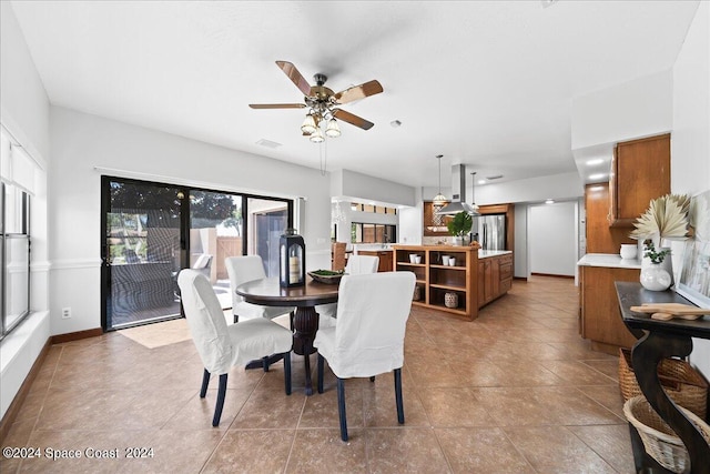 tiled dining room featuring ceiling fan