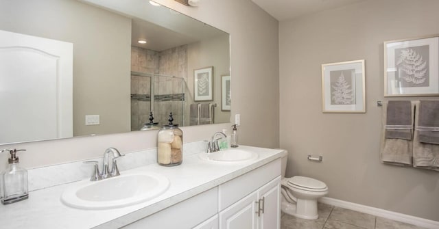 bathroom featuring vanity, a shower with shower door, tile patterned floors, and toilet