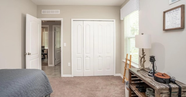 carpeted bedroom featuring a closet