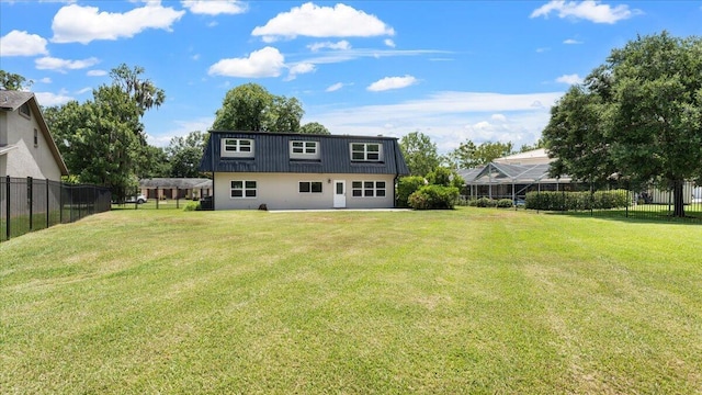 back of property featuring a lawn