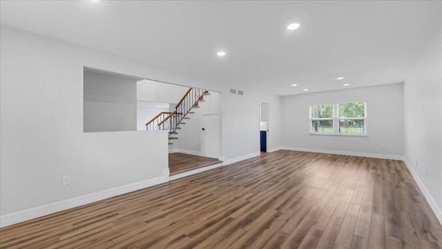 unfurnished living room featuring wood-type flooring