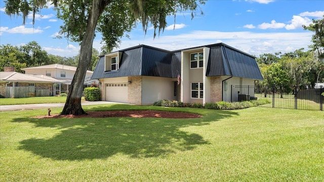 view of front of house featuring a garage and a front lawn