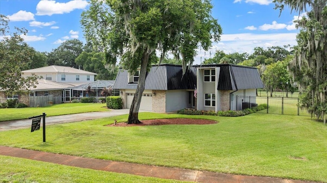 view of front of house featuring a garage and a front lawn