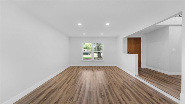 spare room featuring dark hardwood / wood-style flooring