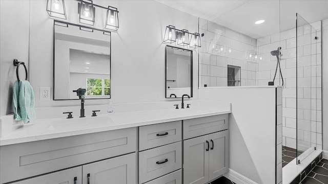 bathroom featuring vanity and tiled shower