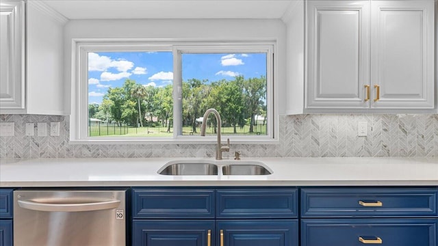 kitchen with stainless steel dishwasher, blue cabinets, sink, and white cabinets