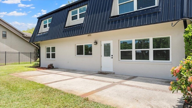 back of house featuring a patio and a lawn