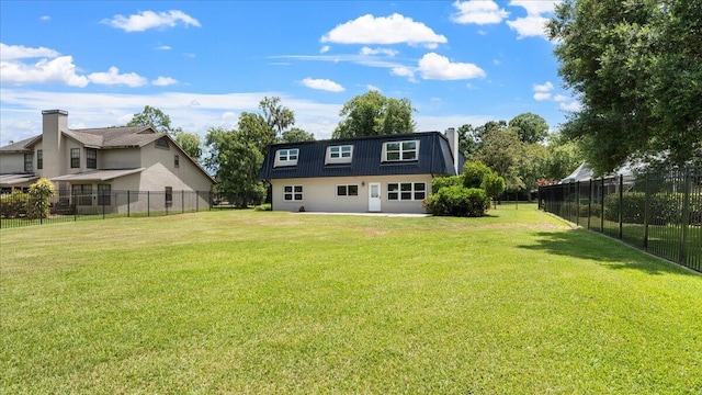 back of house featuring a yard