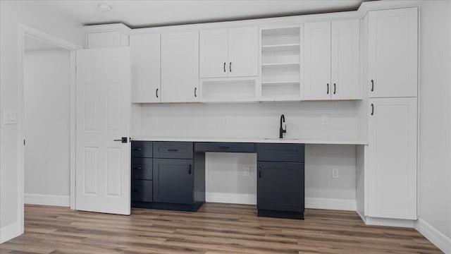 kitchen with gray cabinets, sink, white cabinets, and dark hardwood / wood-style floors